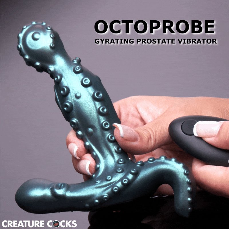 Creature Cocks Octoprobe: A teal, octopus-themed prostate vibrator with textured suction cups held by a hand with remote.