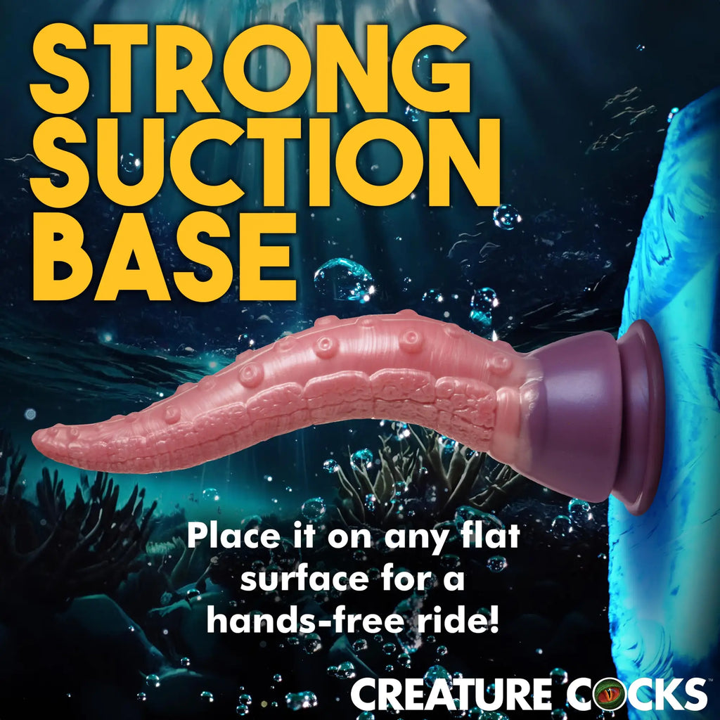 Creature Cocks Octoprobe: A textured, pink silicone tentacle dildo with a purple suction base in an underwater setting.