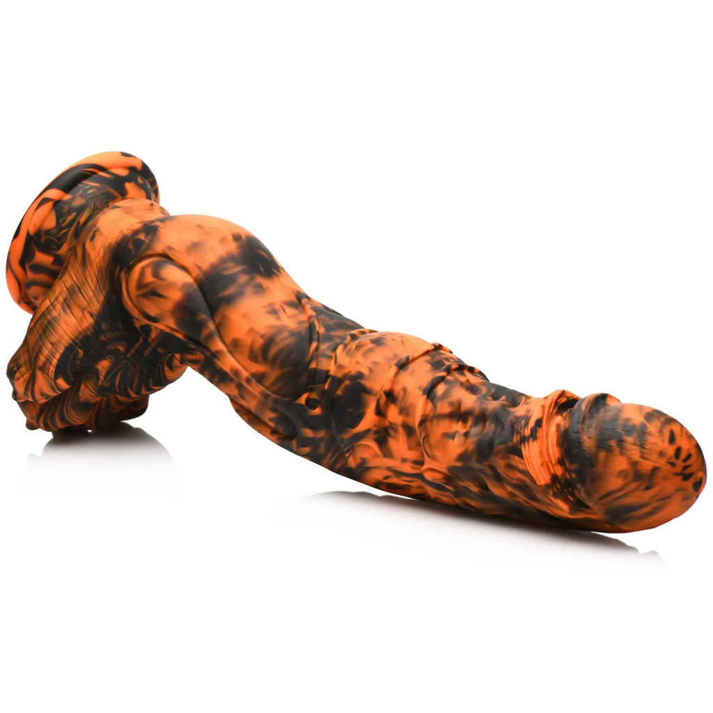 Creature Cocks Sabretooth silicone dildo in a textured black and orange marbled finish with a flared base.