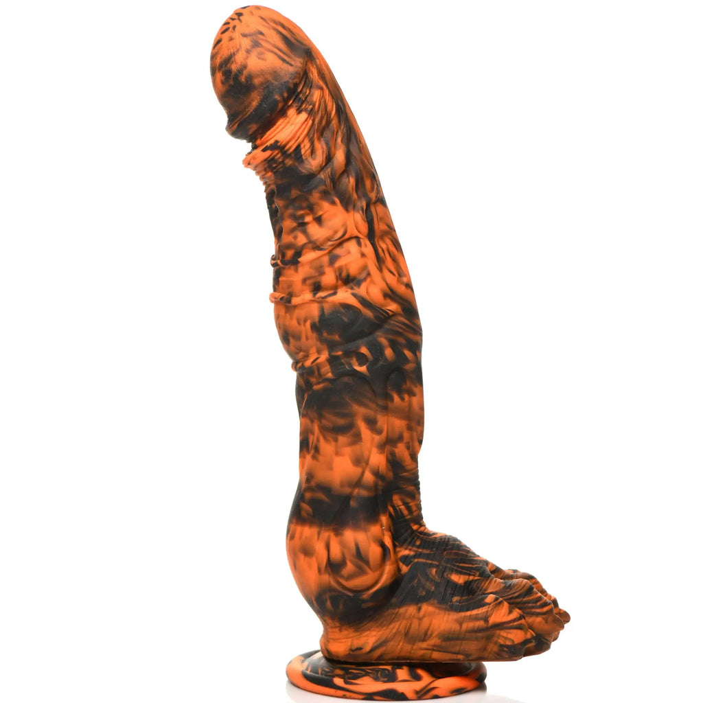 Creature Cocks Sabretooth silicone dildo in a black and orange marbled swirl finish with detailed textured features.