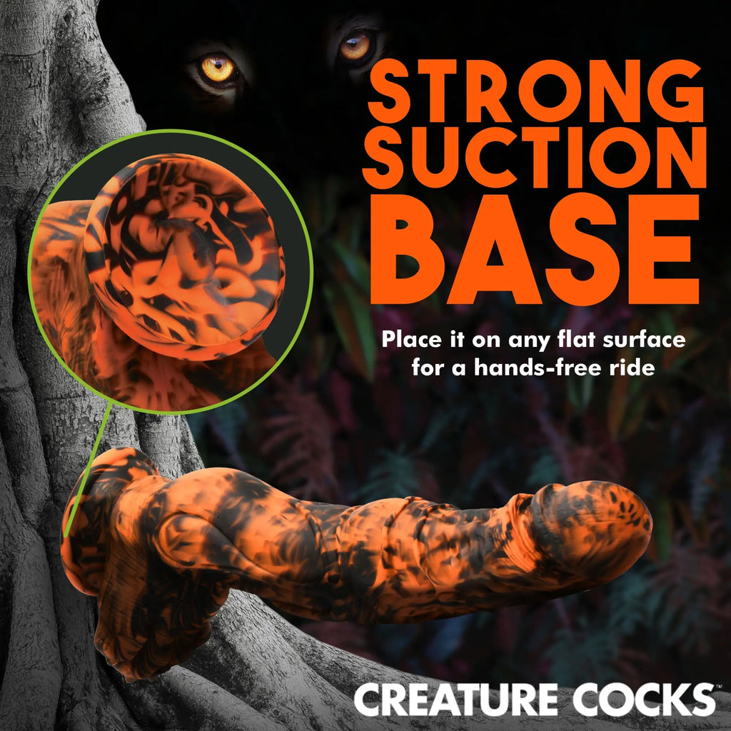 Creature Cocks Sabretooth silicone dildo in black and orange marbled swirl with a prominent suction cup base.