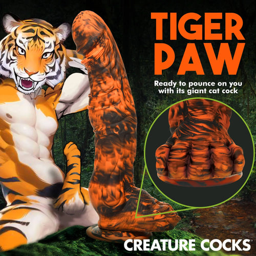 Creature Cocks Sabretooth silicone dildo in orange and black tiger-striped pattern with a paw-shaped base.