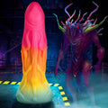 Creature Cocks Shape Shifter silicone dildo: a pink-to-yellow gradient alien-themed toy next to a spiky alien creature.