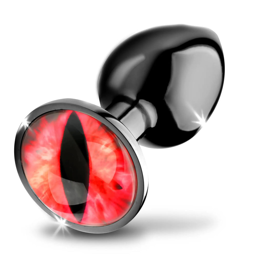 Creature Cocks Sinister Eye metal butt plug featuring a black metallic finish and a vibrant red reptilian eye base.