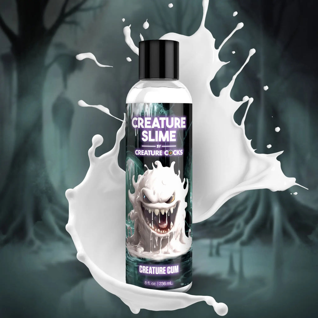Creature Cocks Creature Slime lubricant bottle featuring a grinning white monster graphic against a white liquid splash.