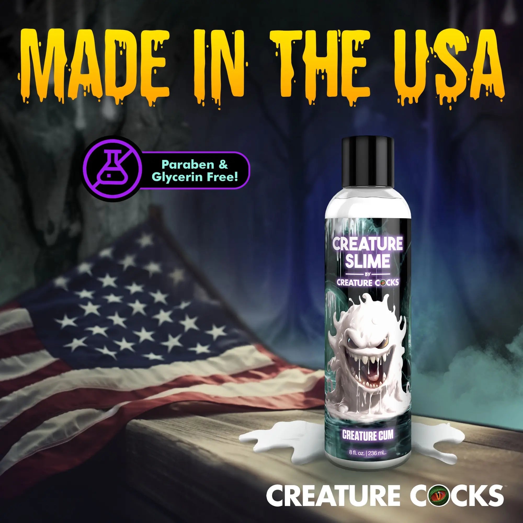 Creature Slime lubricant bottle with white monster graphic on a wooden surface with a US flag background.