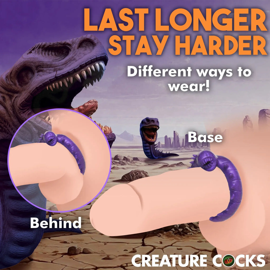 Creature Cocks Slitherine purple silicone cock ring shown in two wearing styles against a prehistoric background.