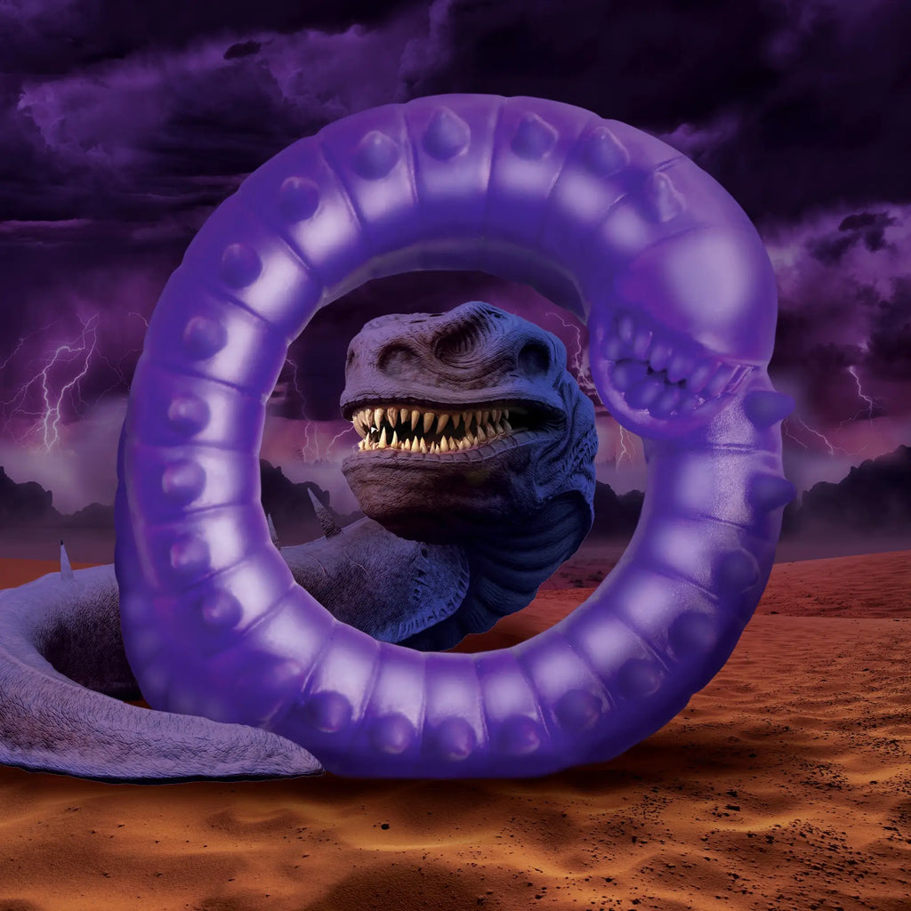 Creature Cocks Slitherine purple silicone cock ring with a textured, segmented design, centered before a monster head.