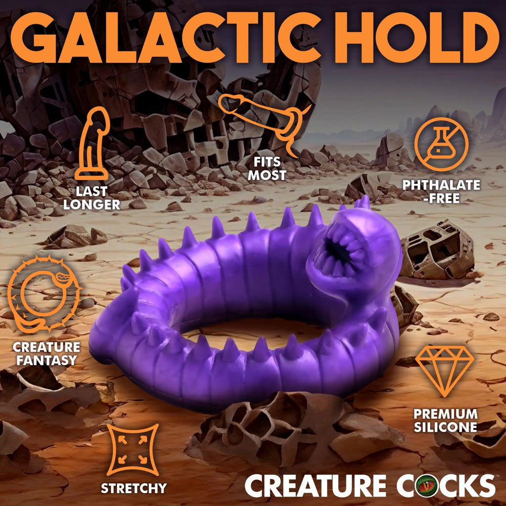 Creature Cocks Slitherine purple silicone cock ring with a monster-inspired, spiky, worm-like design on a desert background.