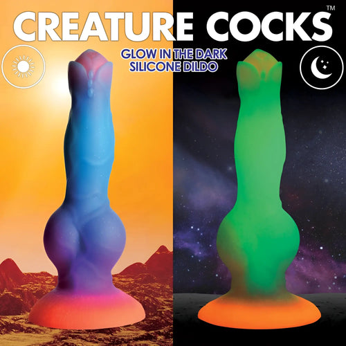 Creature Cocks Space dildo: a blue-to-pink silicone alien toy shown in daylight and glowing green in the dark.