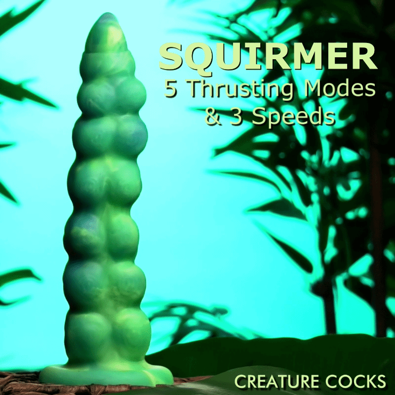 Creature Cocks Squirmer silicone dildo: a green, textured, segmented thrusting toy against a tropical leaf background.