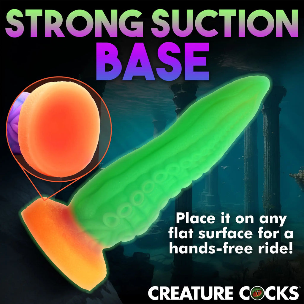 Creature Cocks Tenta-Cock: A glow-in-the-dark green tentacle dildo with an orange suction base against an underwater scene.