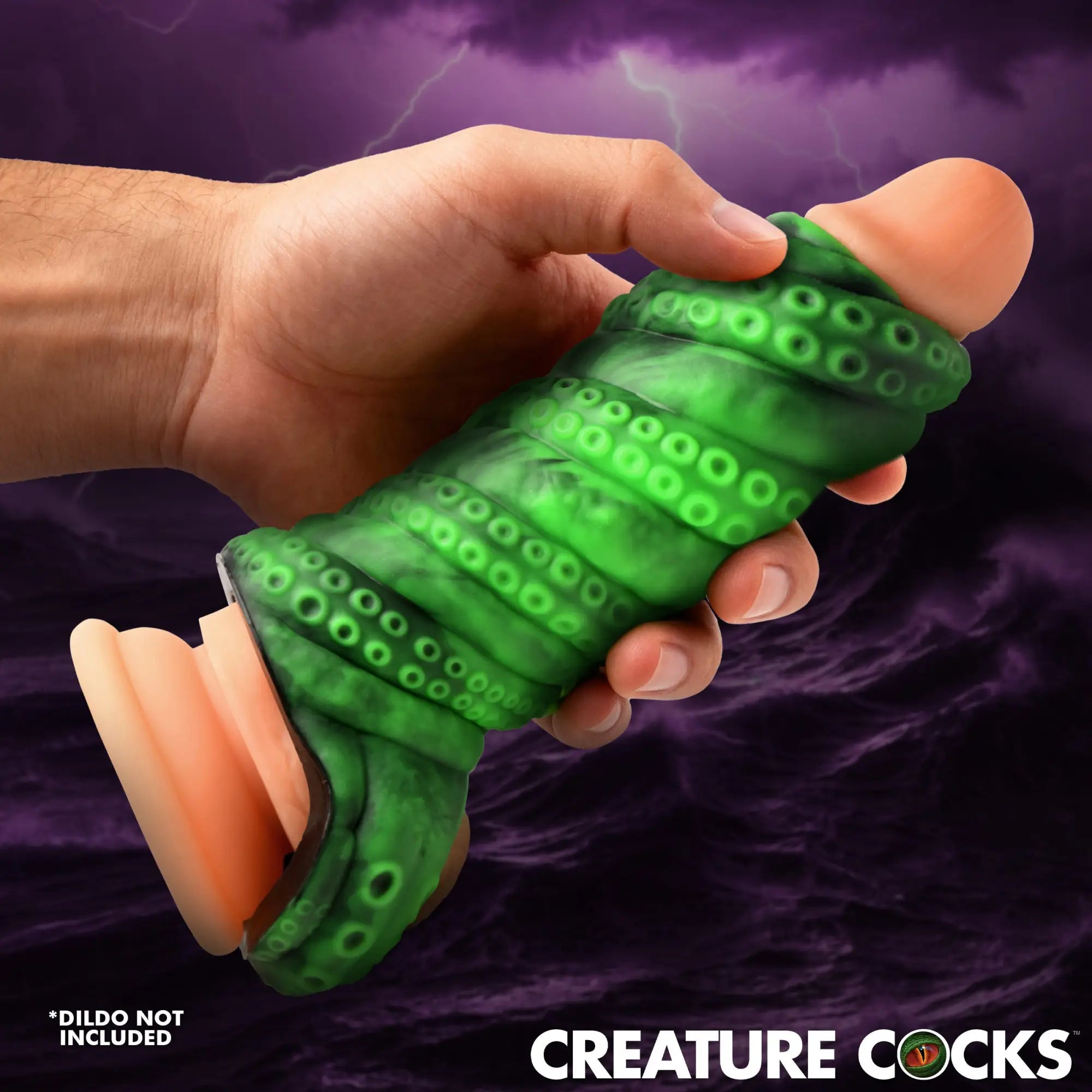 Creature Cocks Tenta Girth green, tentacle-textured silicone sleeve held in a hand over a stormy purple background.