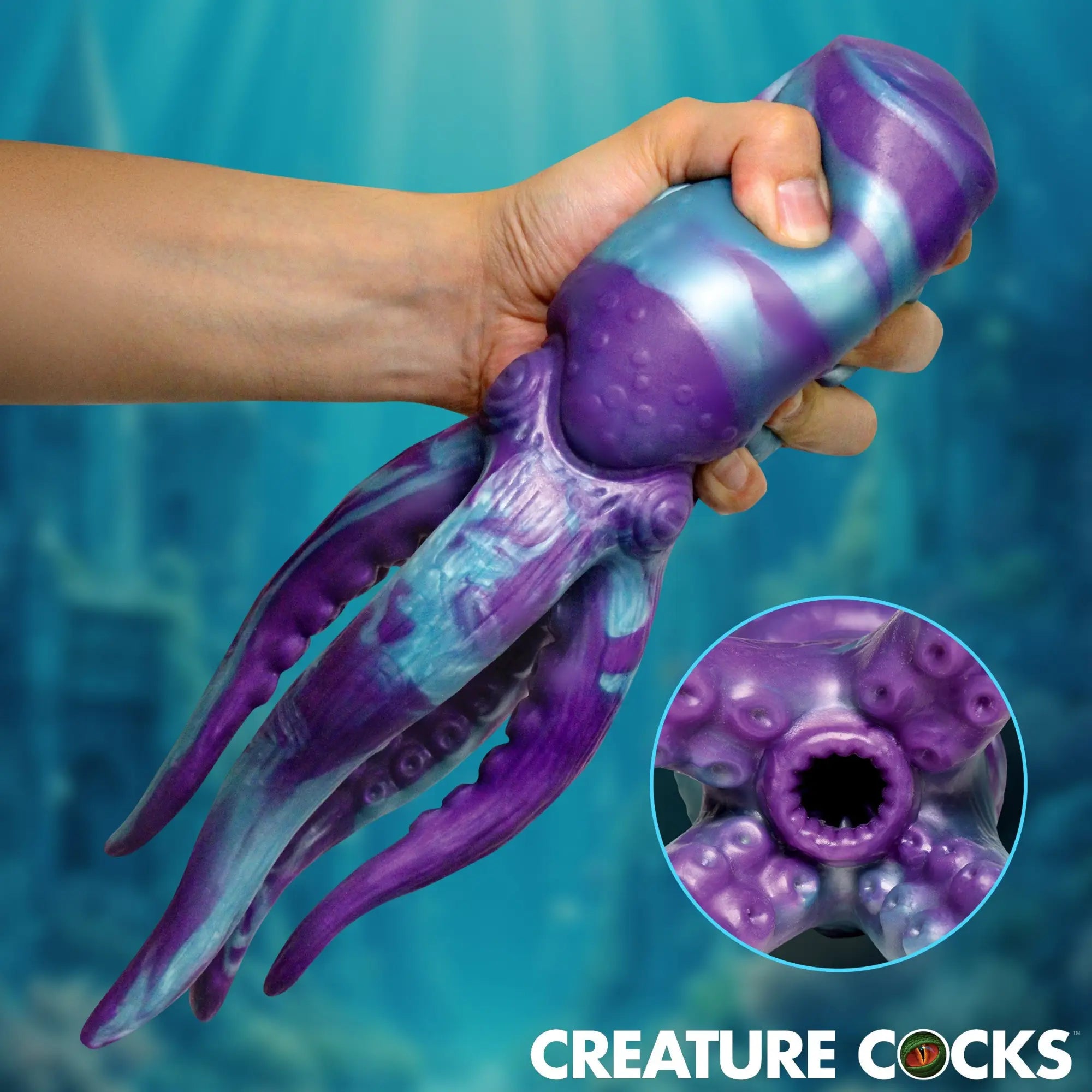 Creature Cocks Tenta Stroke: A purple and blue, octopus-shaped silicone masturbator held in hand, showing tentacle base.