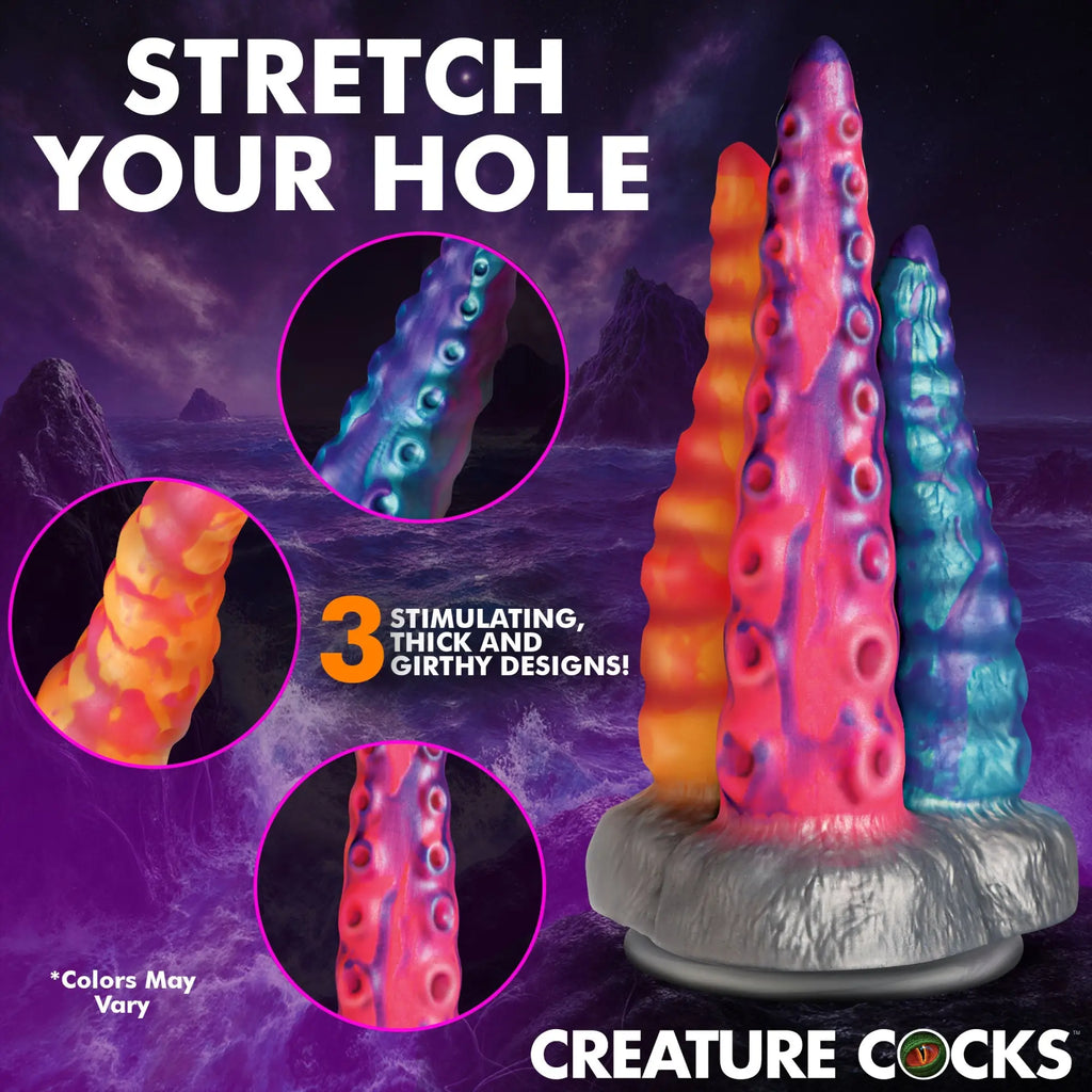 Creature Cocks Tenta-Trio silicone dildo: three textured, tentacle-shaped toys in orange, pink/purple, and teal/purple.