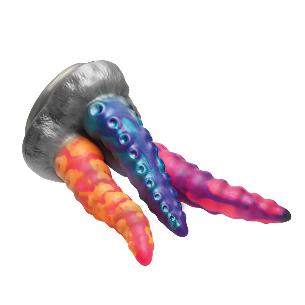 Creature Cocks Tenta-Trio silicone dildo: a grey base with three textured, multi-colored tentacle-style shafts.