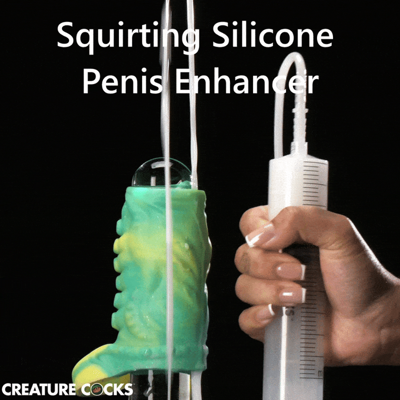 Creature Cocks green and yellow tentacle penis enhancer with a hand-held syringe squirting fluid.