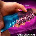 Creature Cocks Tentagirth silicone penis enhancer in sparkly blue and purple with tentacle-style suction cups.