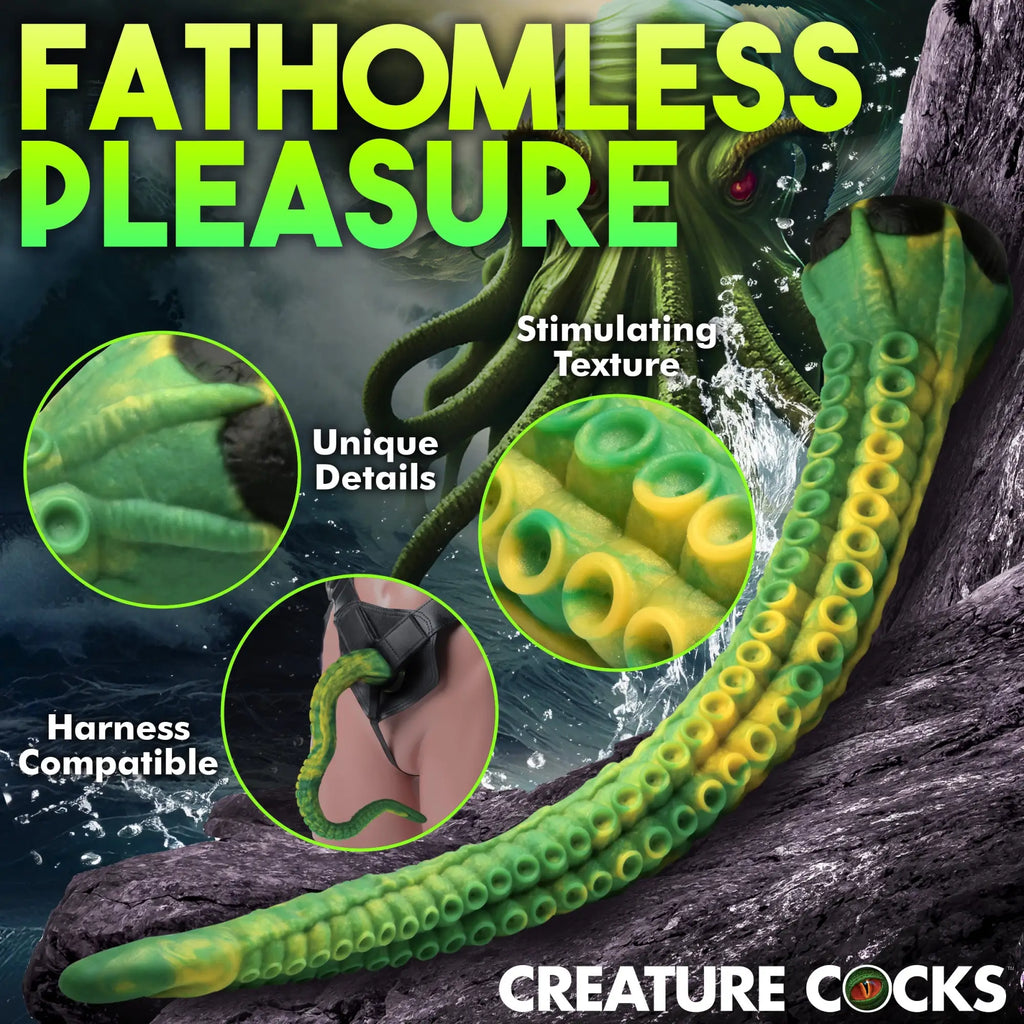 Creature Cocks Titan tentacle dildo in green and yellow silicone with suckers, shown as a long, harness-compatible toy.