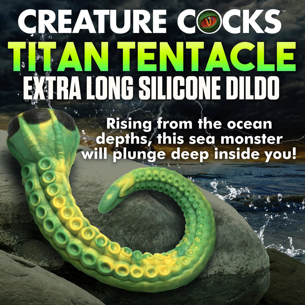 Creature Cocks Titan Tentacle: An extra-long, curved green and yellow silicone dildo with suction cup details on rock.