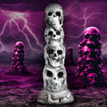 Creature Cocks Tower of Doom silicone dildo: a stack of white and grey skulls against a purple lightning background.