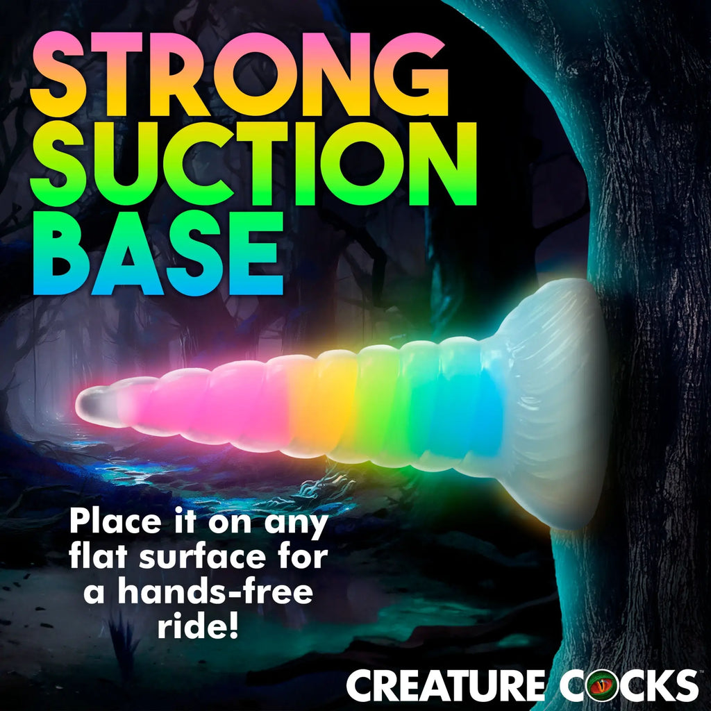 Creature Cocks Uni-Glow dildo: a ribbed, rainbow-colored, glow-in-the-dark silicone toy with a large suction base.