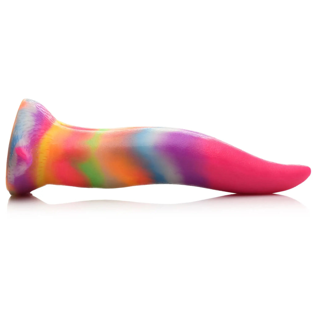 Creature Cocks Unicorn Kiss silicone dildo in a vibrant, multi-colored tie-dye pattern shaped like a long, curved tongue.
