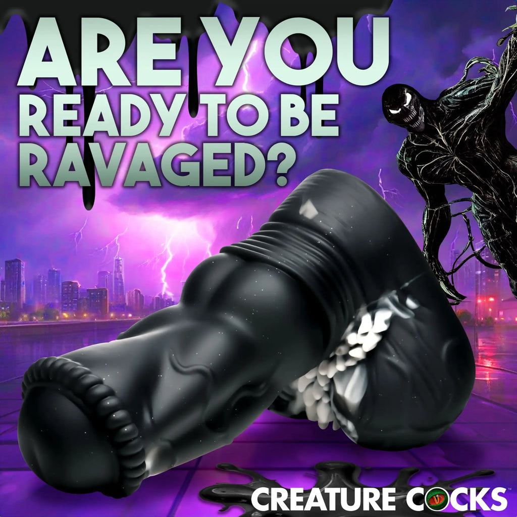 Creature Cocks Venom silicone dildo, a black, textured fantasy-style toy against a purple, city-themed Venom backdrop.