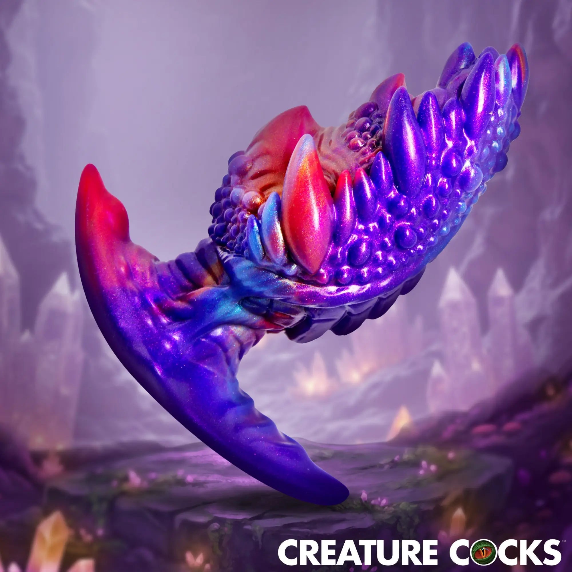Creature Cocks Volkron silicone butt plug, a purple and pink fantasy-textured toy with spikes on a crystal background.