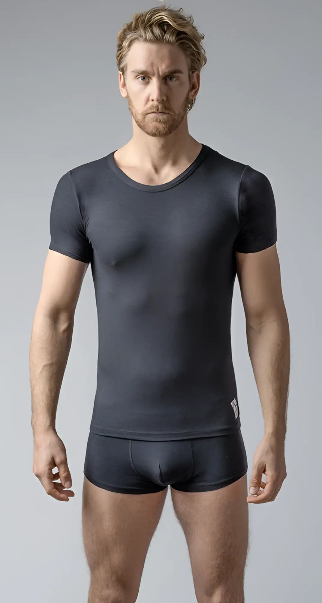 Black short-sleeved crew neck t-shirt made of stretchy fabric worn with matching shorts for casual wear