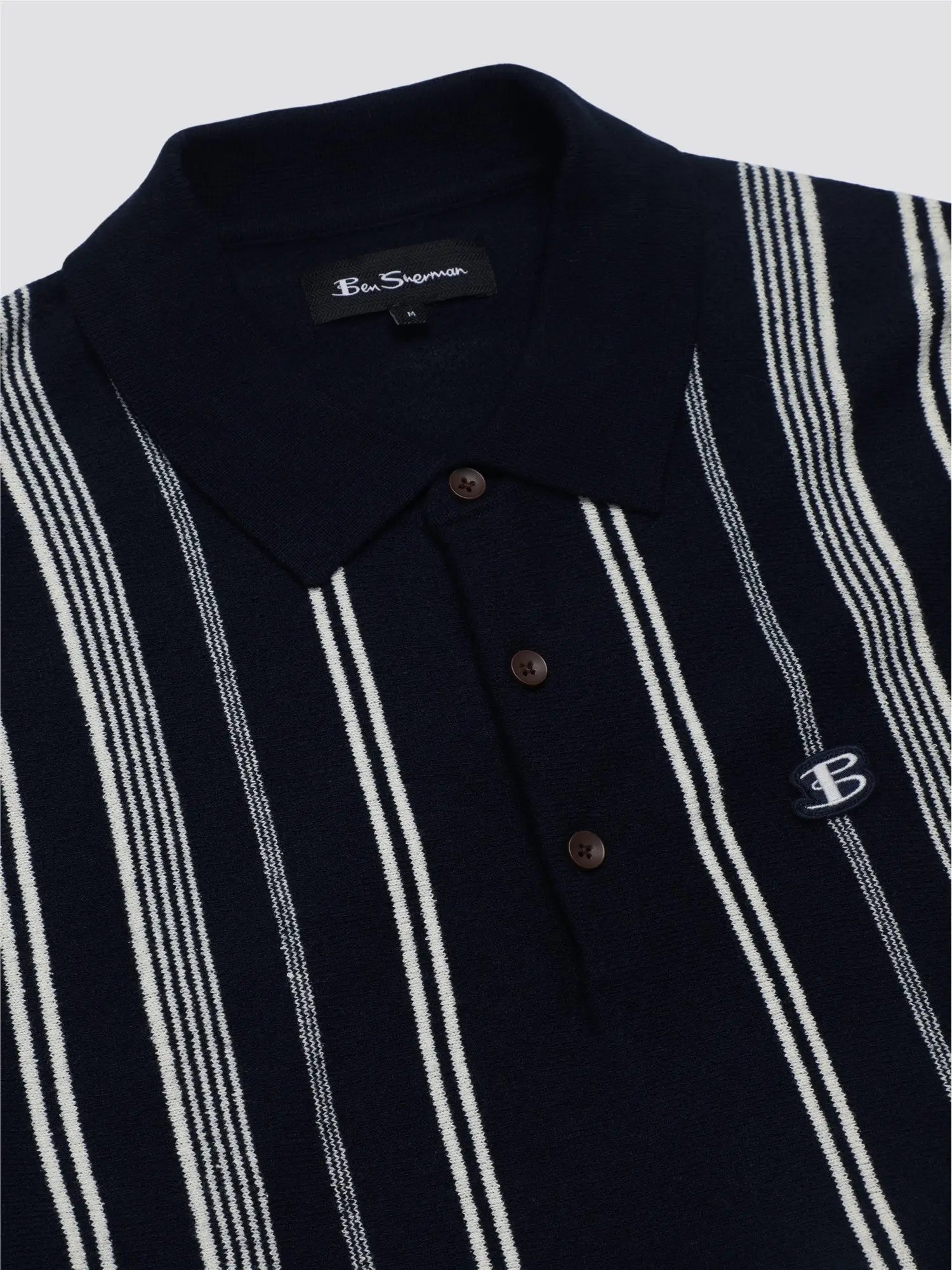 Navy blue and white striped crinkle cotton knit polo shirt with a small embroidered logo on the chest