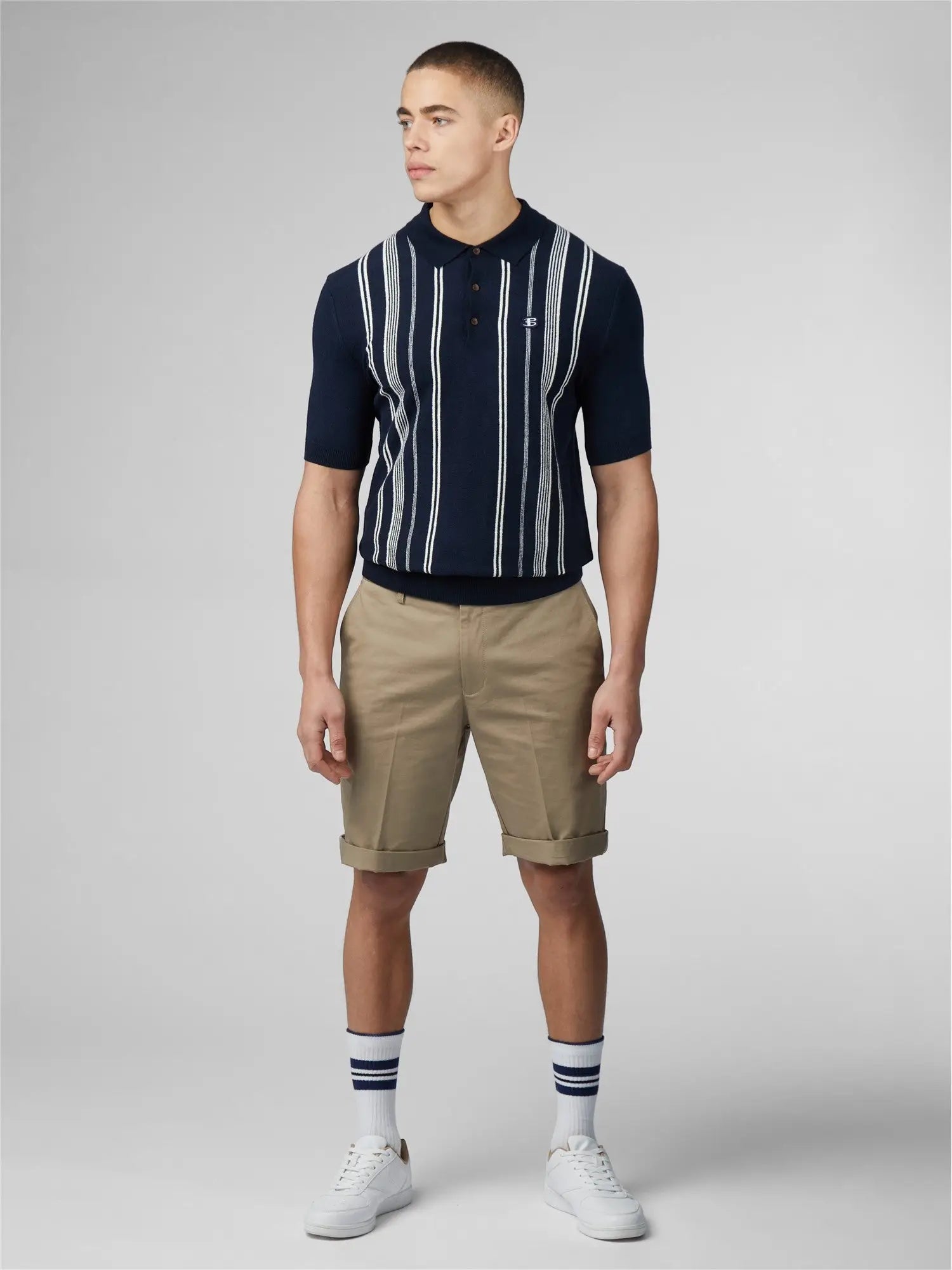 Navy blue and white vertically striped short-sleeved crinkle cotton stripe polo shirt with a small chest logo