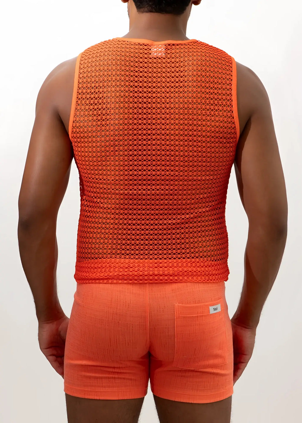 Orange crochet muscle tank top with breathable textured mesh fabric and small brand tag at the neckline