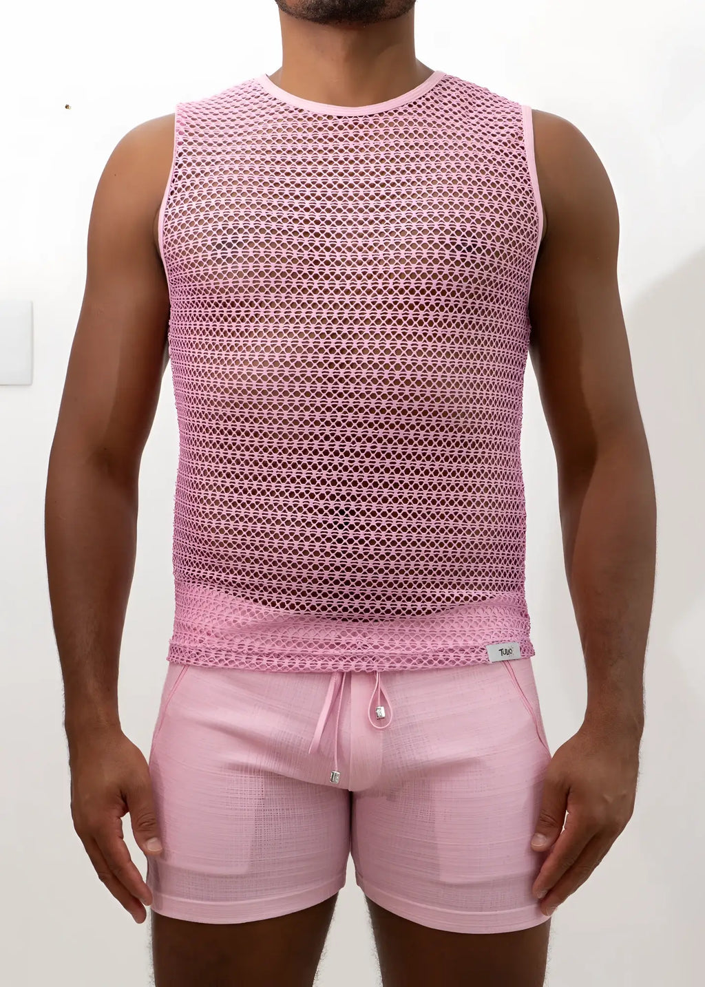 Pink crochet muscle tank top with sleeveless mesh design and subtle geometric pattern with round neckline