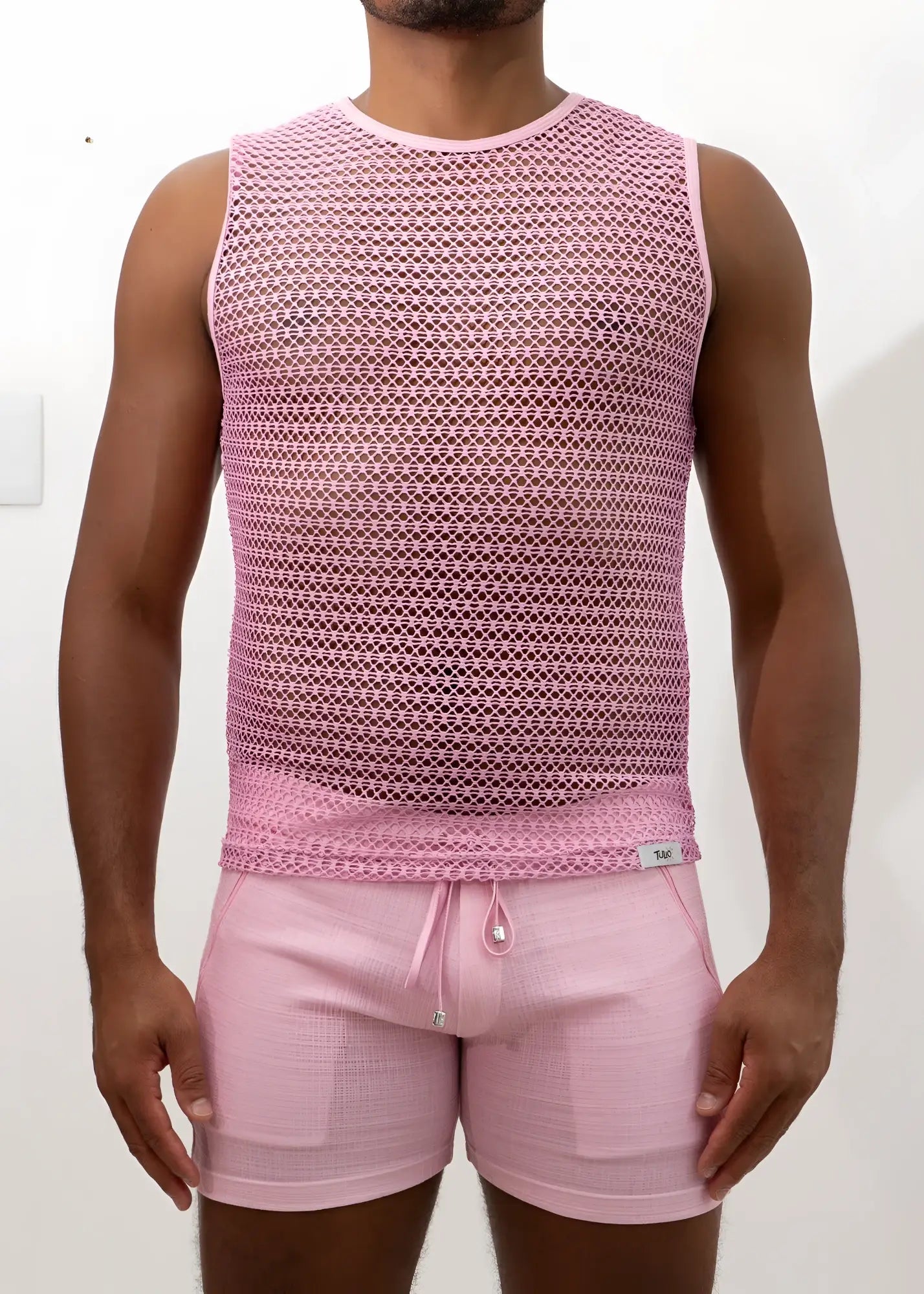 Pink crochet muscle tank top with sleeveless mesh design and subtle geometric pattern with round neckline