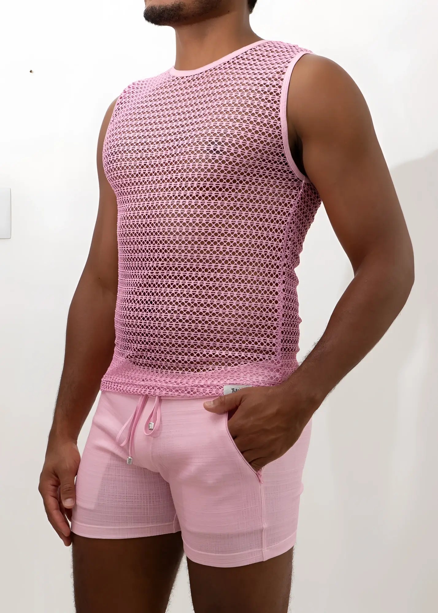 Pink crochet muscle tank top with subtle geometric mesh pattern paired with matching pink drawstring shorts