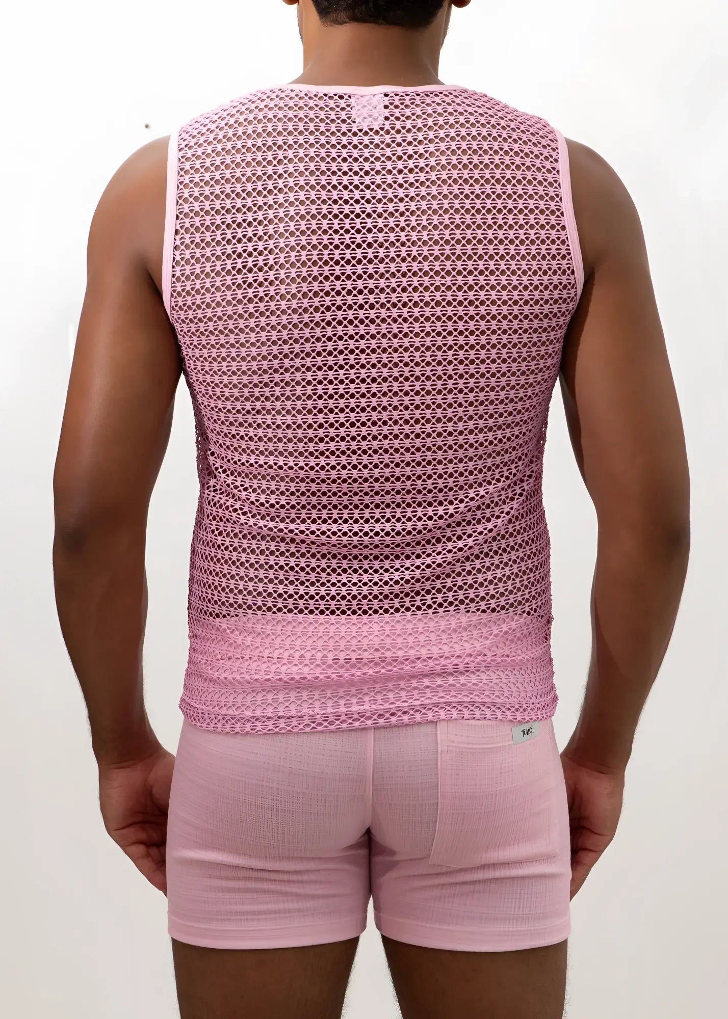 Pink crochet muscle tank top featuring a mesh fabric with a subtle geometric pattern and ribbed hem