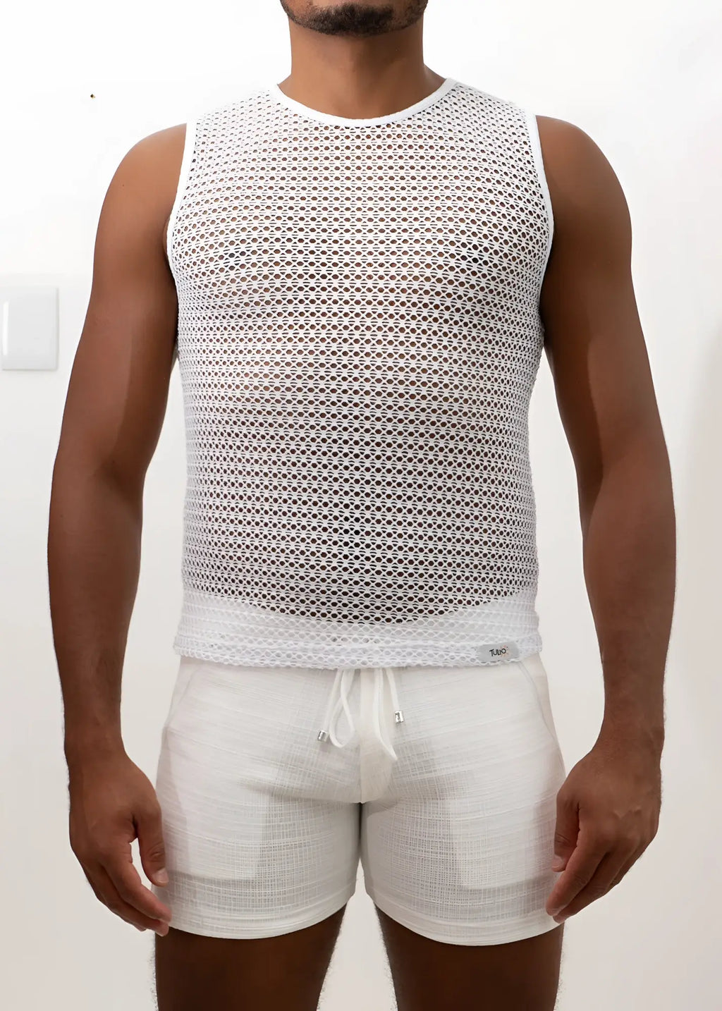White crochet muscle tank top with mesh fabric round neckline and elasticated waistband for casual wear