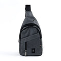 Crossbody sling bag made of gray textured fabric with black zipper pulls and a small black logo patch