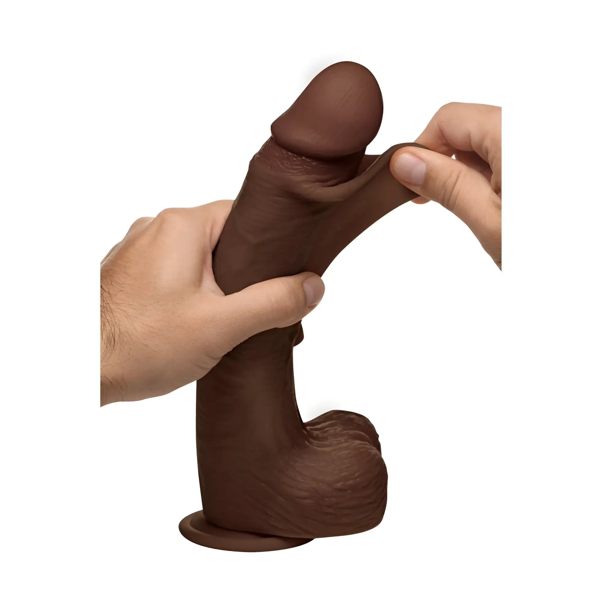 Curve Toys 10-inch dark brown silicone dildo with balls, being stretched by hands to show its flexible, realistic texture.