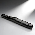 Curve Toys 13-inch tapered black double-ended dong with a realistic texture, shown against a grey spotlight background.