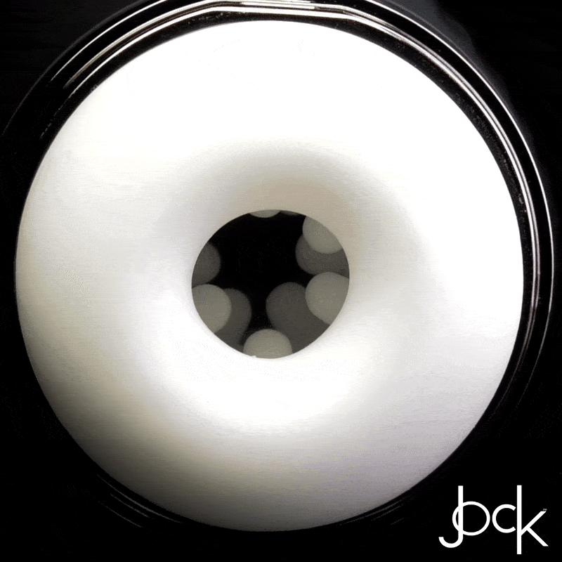 Curve Toys 15X Masturbator: A white, ring-shaped sleeve with internal textured nubs, shown against a black background.