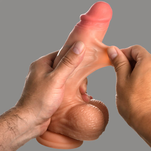 Curve Toys 8-inch realistic silicone dildo with balls, showing flexible, stretchable skin-like material being pulled.
