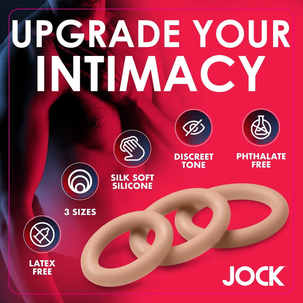 Curve Toys Discreet Silicone Cock Ring Set: three beige, smooth silicone rings in varying sizes against a pink background.