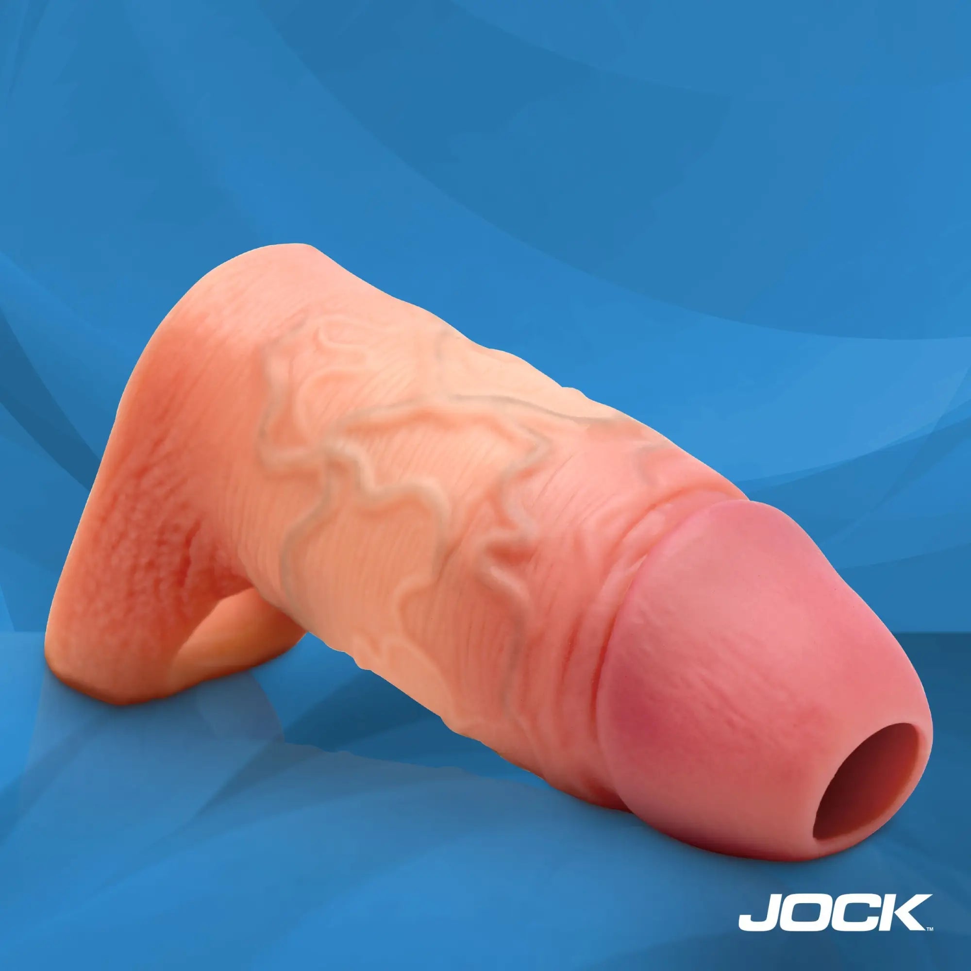 Curve Toys flesh-toned penis enhancer with realistic vein detail, textured finish, and integrated ball strap.