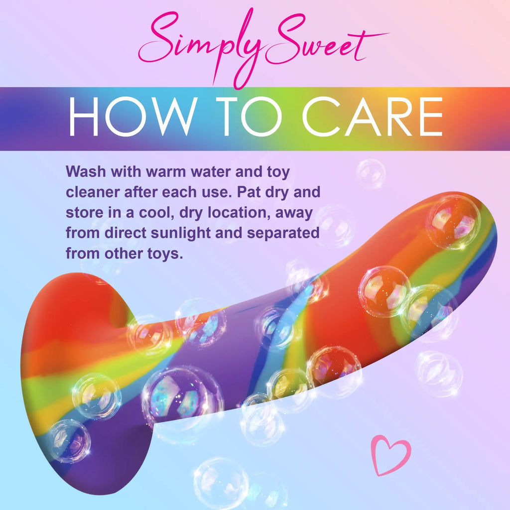 Curve Toys rainbow silicone dildo surrounded by bubbles, with care instructions text on a pastel gradient background.