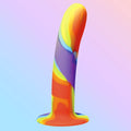 Curve Toys rainbow silicone dildo featuring a smooth, curved shape with a multi-colored, marbled swirl pattern.