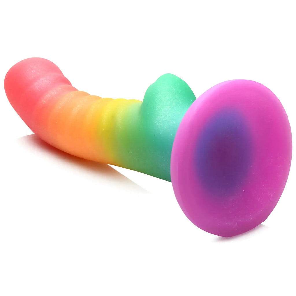 Curve Toys Ribbed Rainbow Silicone Dildo with a suction cup base, featuring a curved, multi-colored textured shaft.