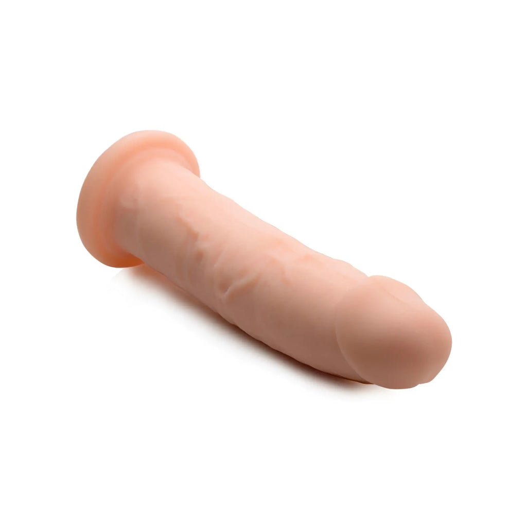 Curve Toys Silexpan hypoallergenic silicone dildo in a realistic skin tone with a flared base, isolated on white.