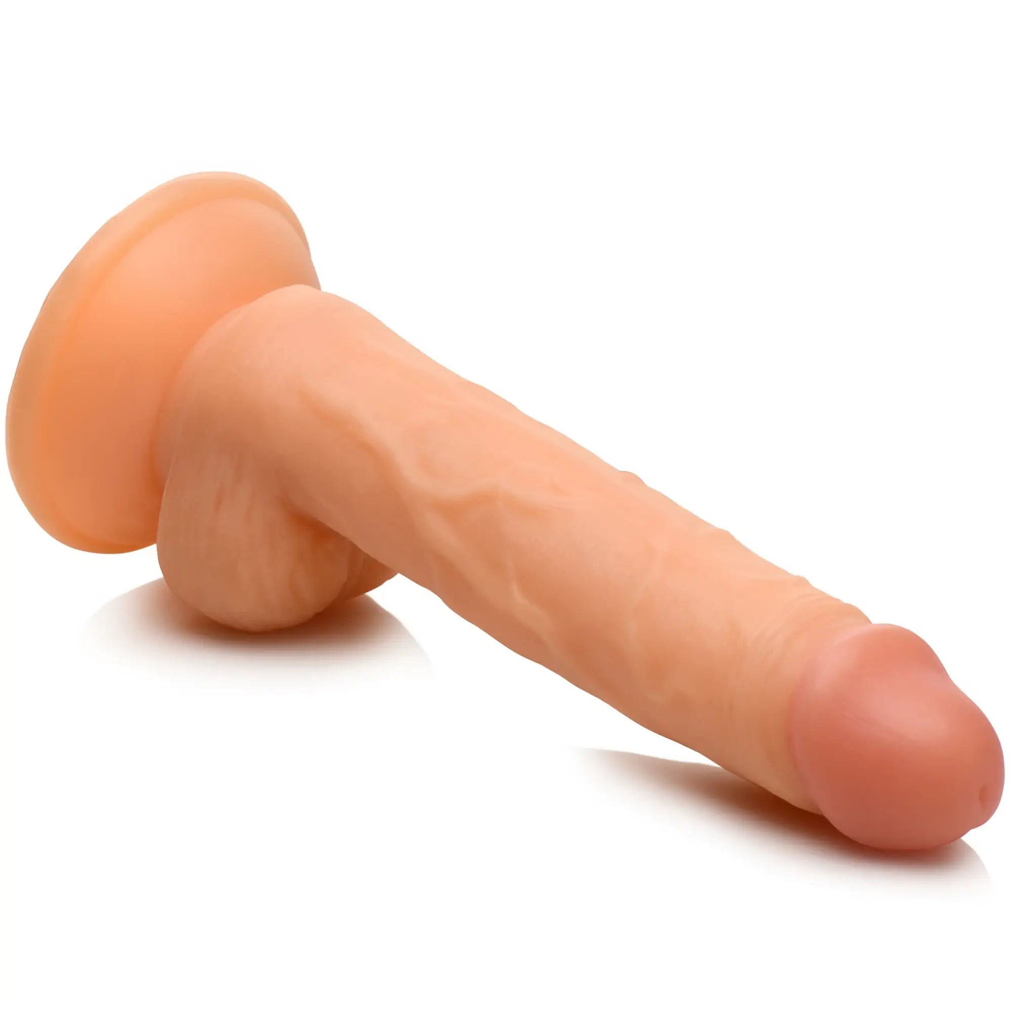 Curve Toys Swimming Simon 7-inch flesh-colored dildo with a realistic texture, base, and testicles on a white background.